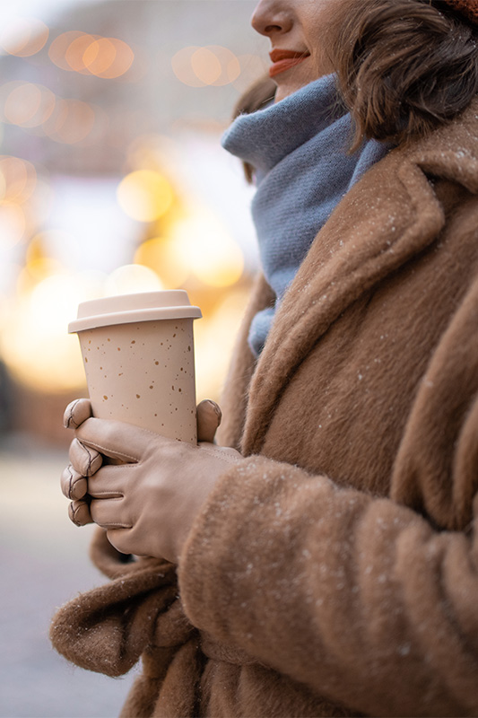 Woman with takeaway coffee on the Christmas market