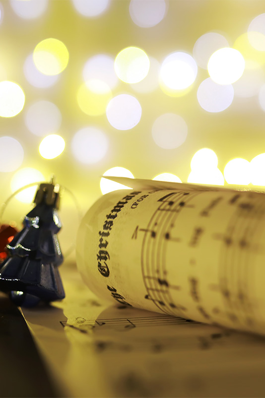 Christmas decorations on music sheets, closeup