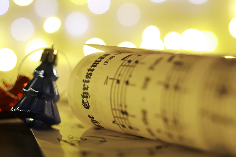 Christmas decorations on music sheets, closeup